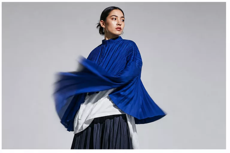 Model in a cobalt pleated wrap in motion.